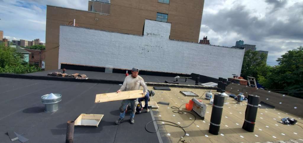 Flat Roof Installation, New Skylight, New Gutters and New Shingle Project Shot 1