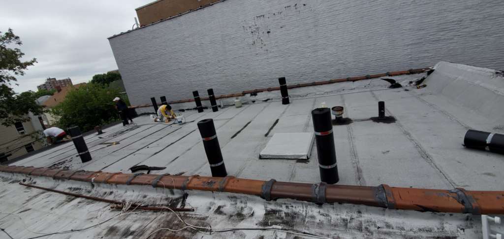Flat Roof Installation, New Skylight, New Gutters and New Shingle Project Shot 8