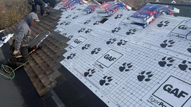 Shingle roof installation in progress in Throgs Neck, Bronx. Roofing team removing old shingles, preparing roof deck, and installing underlayment for durable and long-lasting results.