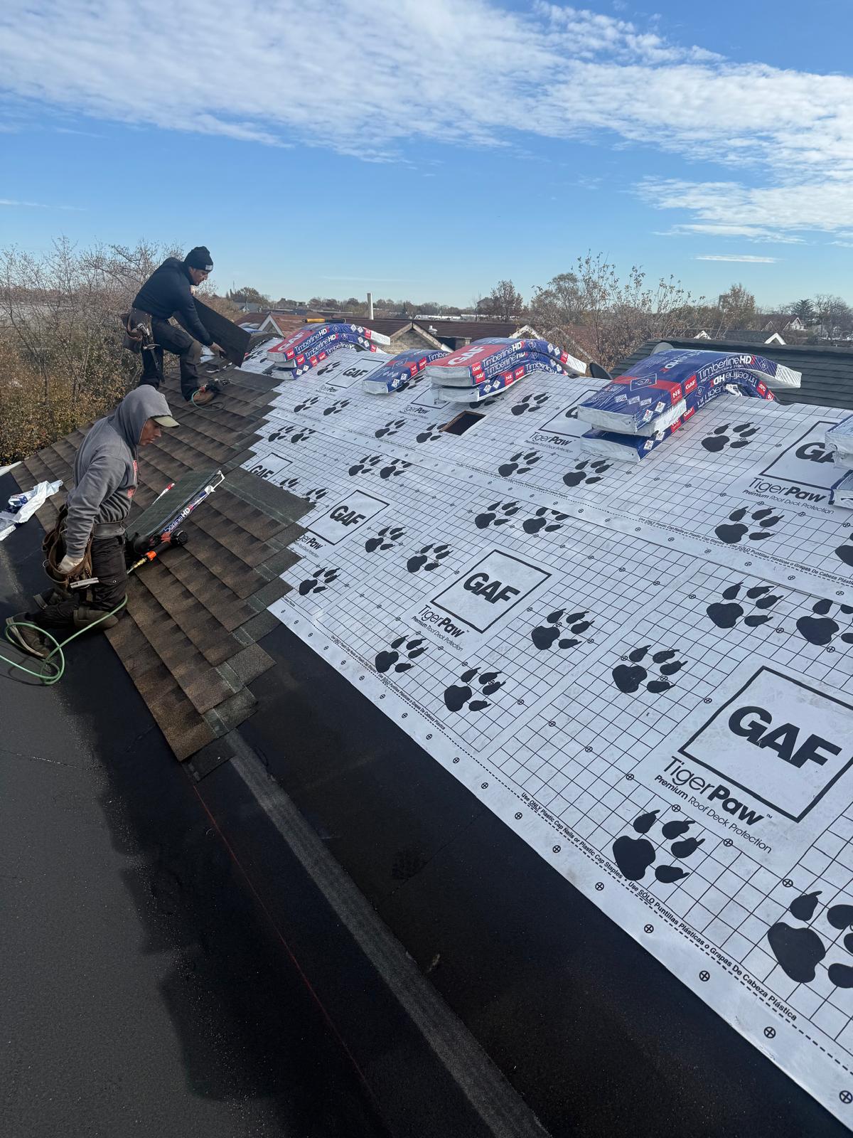 Shingle roof installation in progress in Throgs Neck, Bronx. Roofing team removing old shingles, preparing roof deck, and installing underlayment for durable and long-lasting results.