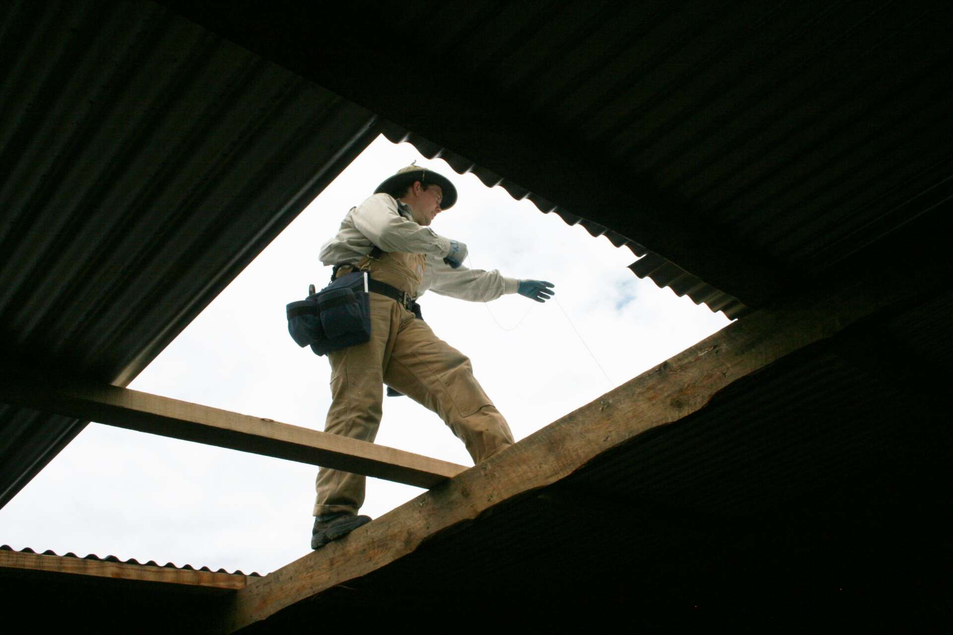 Professional inspecting a skylight for leaks